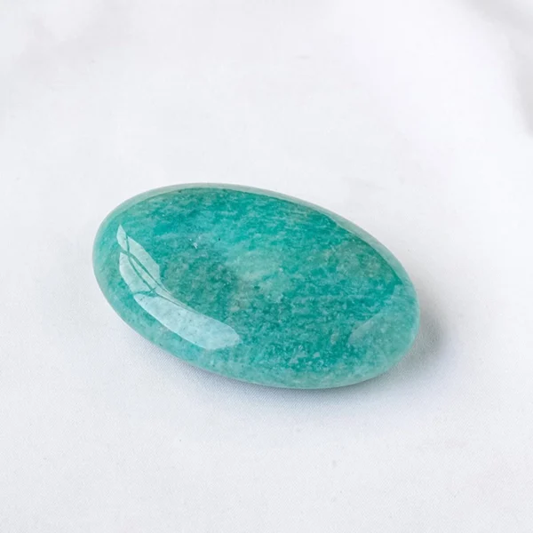 Let truth flow gently from heart to voice as you hold the Amazonite Palm Stone. Calm, balancing, and quietly transformative, it supports authentic expression while guiding inner growth.