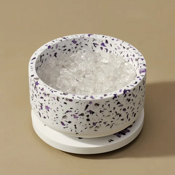 The Amethyst Gypsum Bowl is a powerful purification tool designed for crystals. Combining amethyst's ability to absorb negative energy with gypsum's purifying properties, it recharges and restores crystals. Place crystals inside the bowl to clear negative energies and recharge their energy. The bowl can also purify spaces, creating a harmonious environment. To use, place crystals inside, leave them for at least 12 hours, and position the bowl in your home, office, or meditation space to enjoy its benefits. This revitalizes your crystals and contributes to a fresh, energized atmosphere.