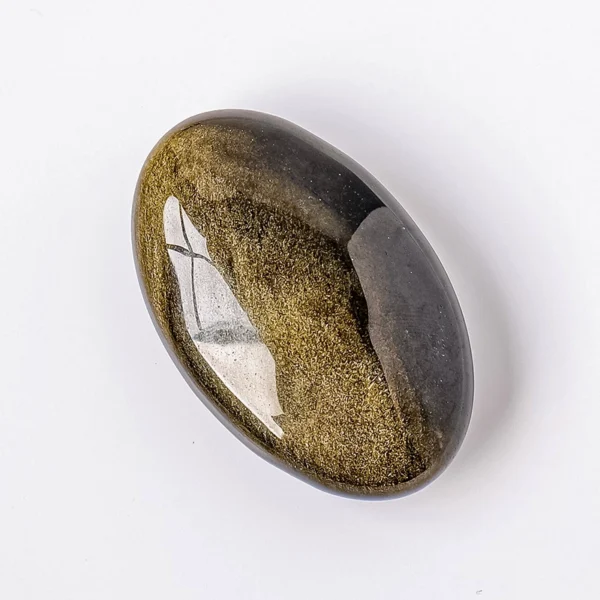 Hold steady abundance and deep transformation with the Golden Obsidian Palm Stone. Its dark surface reveals a soft golden glow, inviting clarity, prosperity, and grounded change into your life.