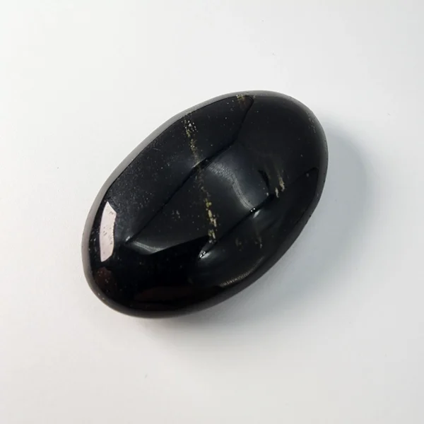 Hold steady abundance and deep transformation with the Golden Obsidian Palm Stone. Its dark surface reveals a soft golden glow, inviting clarity, prosperity, and grounded change into your life.