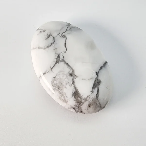 Let the mind grow quiet and awareness expand as you hold the Howlite Palm Stone. Soft, calming, and inwardly centering, it supports spiritual clarity while easing mental noise.