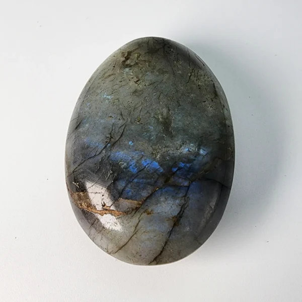 Let transformation unfold gently as you hold the Labradorite Palm Stone. Shimmering with quiet mystery, it supports change while protecting your inner light and intuition.
