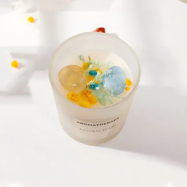 This candle blends the energies of citrine and aquamarine crystals, essential oils, and dried flowers, creating a peaceful and positive energy field. Citrine, the crystal of abundance, clears negativity, enhances optimism, and boosts confidence, making it perfect for attracting wealth. Aquamarine promotes emotional balance, clear thinking, and stress reduction. The combination fosters an atmosphere that is both calm and energizing. The soothing fragrance enhances purification, creating a fresh environment. To use, light the candle on a stable surface, use during meditation, yoga, or relaxation, and place it in any space needing purification. Always use safely and avoid leaving it unattended.
