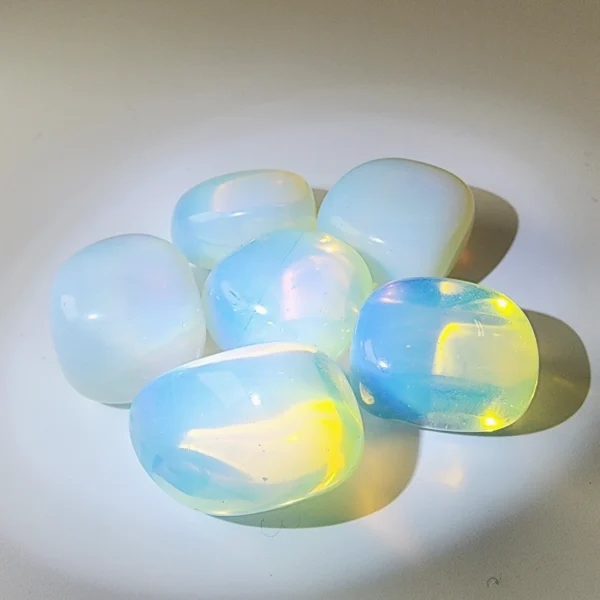 Invite inspiration and emotional flow with the Opal Tumbled Stone. Luminous and expressive, it awakens creativity, nurtures intuition, and supports abundance through emotional clarity.