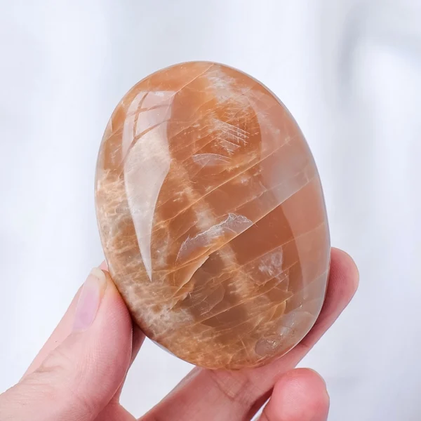 Let gentle healing and intuitive clarity unfold as you hold the Orange Moonstone Palm Stone. Warm, luminous, and softly calming, it supports emotional recovery while awakening higher awareness.