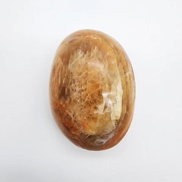 Let gentle healing and intuitive clarity unfold as you hold the Orange Moonstone Palm Stone. Warm, luminous, and softly calming, it supports emotional recovery while awakening higher awareness.