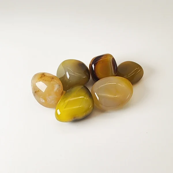 Invite gentle calm and renewed vitality with the Yellow Agate Tumbled Stone. Warm and reassuring, it soothes tension while supporting physical balance and emotional steadiness.