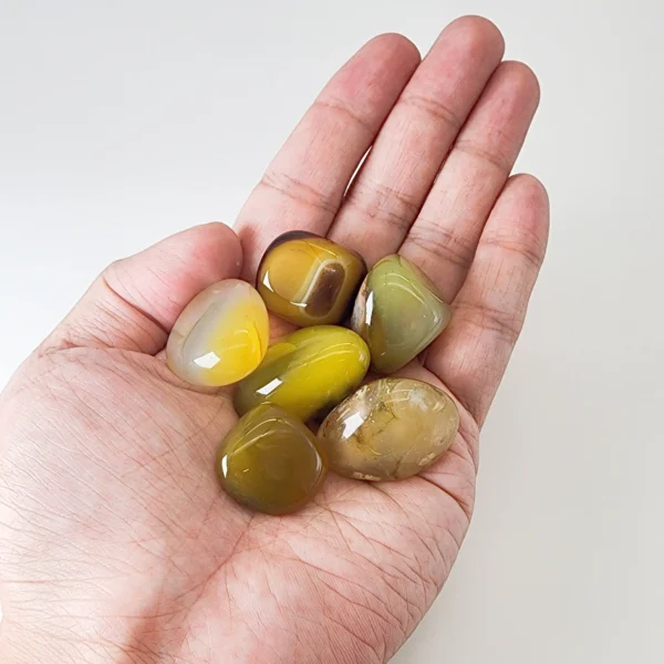 Invite gentle calm and renewed vitality with the Yellow Agate Tumbled Stone. Warm and reassuring, it soothes tension while supporting physical balance and emotional steadiness.