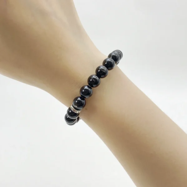The Hypersthene Bracelet promotes grounding, clarity, and spiritual protection. Known for its deep silvery-black sheen, this crystal anchors your energy, helping you stay calm and decisive. It dissolves illusion and confusion while connecting you to the stabilizing rhythm of the earth.