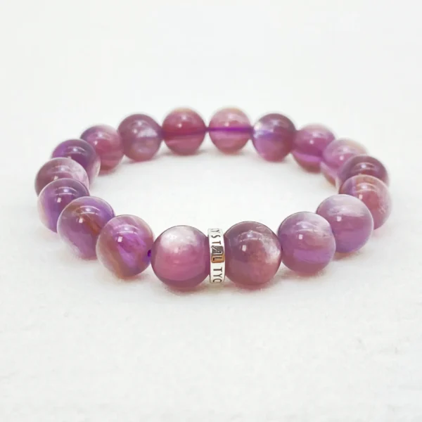 The Lepidolite Bracelet radiates serenity and emotional renewal. Known as the “Stone of Transition,” this soothing crystal calms restless thoughts, balances moods, and nurtures the heart chakra. Ideal for those seeking peace, self-love, and inner clarity, it gently dissolves emotional blockages and invites harmony into your life.