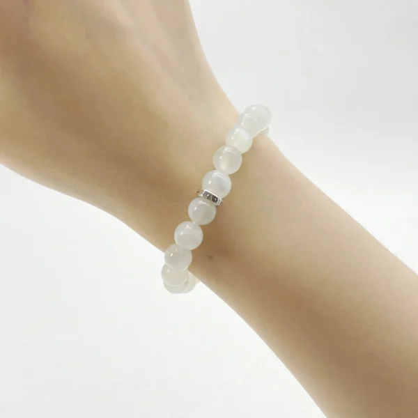 The White Moonstone Bracelet glows with the energy of healing and recovery. Crafted from Authentic AAA Grade gemstones, this luminous piece calms emotions, enhances intuition, and promotes spiritual balance. Connecting the Crown and Third Eye Chakras, it supports emotional renewal and stability in love and life. Ideal for those seeking inner peace and spiritual clarity.