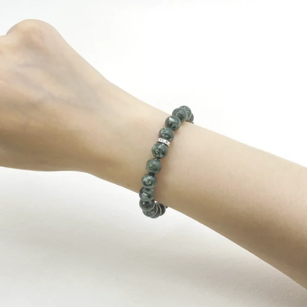 The seraphinite crystals bracelet is crafted from authentic Seraphinite, revered as the Angel Stone for its wing-like patterns symbolizing protection and spiritual upliftment. Ideal for seekers of belonging, emotional healing, and higher guidance, it supports Crown and Heart Chakra alignment. This rare stone deepens intuition and inner peace.