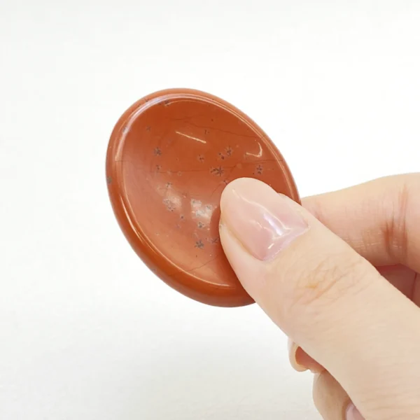 Red Jasper Worry Stone grounds your energy and restores inner stability. Hold deep strength and steady courage in your hands—bring home this grounding stone today.