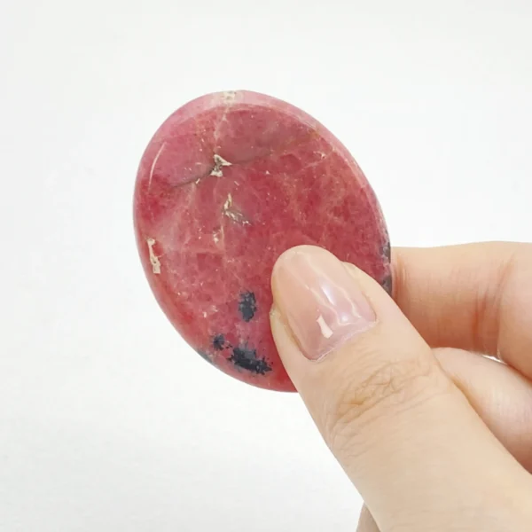 Rhodonite Worry Stone helps ease emotional tension, restores compassion, and supports gentle healing. Hold comfort and clarity in your hand—bring one home today.