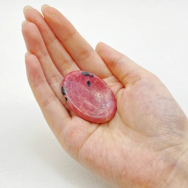 Rhodonite Worry Stone helps ease emotional tension, restores compassion, and supports gentle healing. Hold comfort and clarity in your hand—bring one home today.