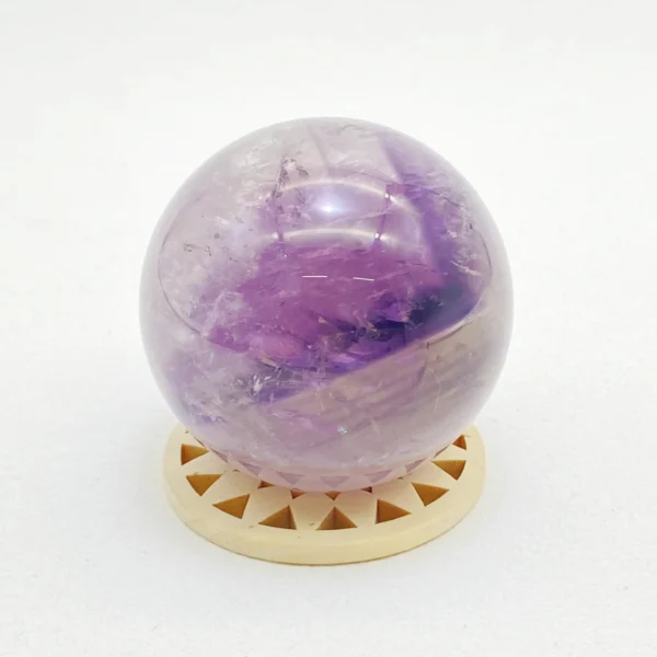 The Amethyst Sphere radiates calm, wisdom, and spiritual clarity. Gently soothing the mind while enhancing intuition, it supports emotional balance and inner peace. Resting securely on its round base, it brings harmony to any space.