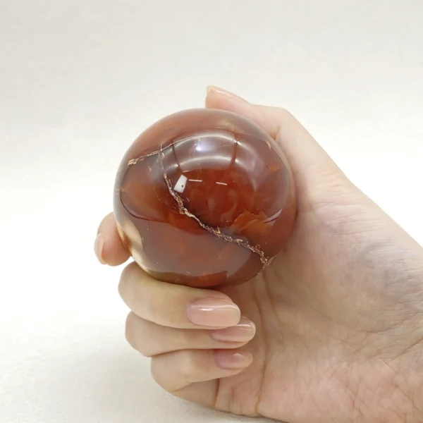 The Red Agate Sphere offers grounding calm and steady vitality, supporting both physical balance and emotional ease. Its gentle, stabilizing energy helps soothe tension while restoring strength from within. Resting securely on its round base, it brings warmth and reassurance to any space.