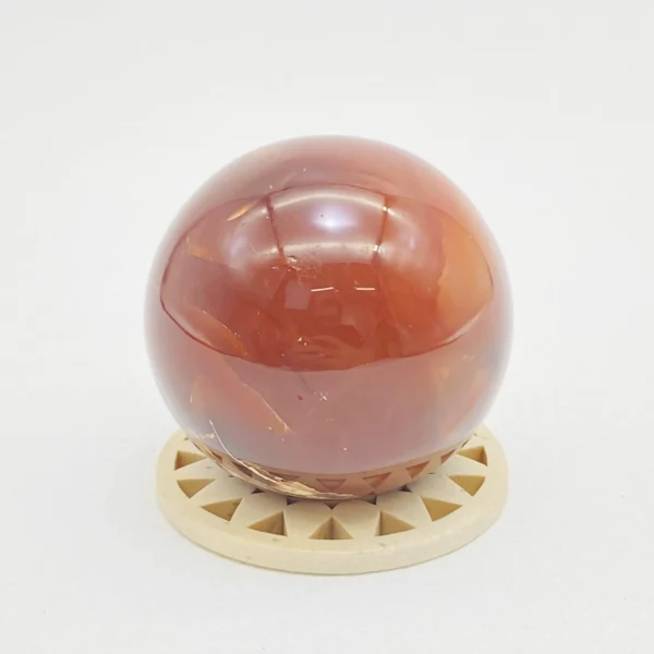 The Red Agate Sphere offers grounding calm and steady vitality, supporting both physical balance and emotional ease. Its gentle, stabilizing energy helps soothe tension while restoring strength from within. Resting securely on its round base, it brings warmth and reassurance to any space.