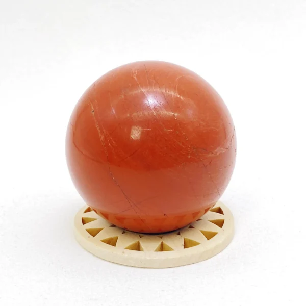 The Red Jasper Sphere radiates grounding strength and steady vitality. Deeply connected to the earth, it supports physical renewal while restoring balance during times of exhaustion. Resting on its round base, it anchors energy and encourages resilience throughout the body.