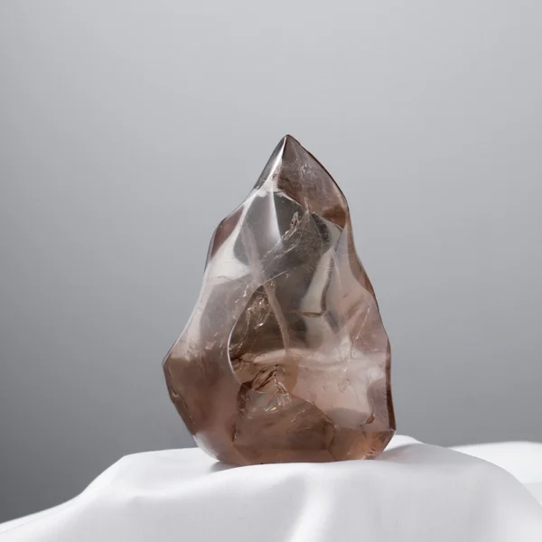 Return gently to strength with the Smoky Quartz Flame, a grounding flame-shaped crystal that supports recovery, stability, and physical vitality. Its steady energy anchors scattered thoughts while nurturing resilience.