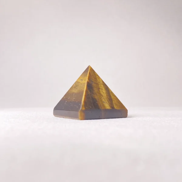 The Tigers Eye Pyramid channels courage, focus, and steady confidence into your space. Its grounding yet energizing presence supports decisive action, personal strength, and clear communication. Ideal for workspaces, study areas, or moments requiring self-assurance, it helps you face challenges with clarity and inner resolve.