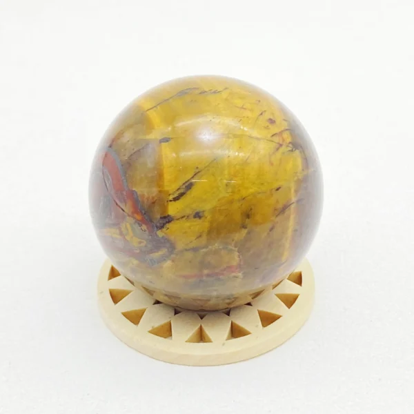 The Tiger’s Eye Sphere radiates confidence, courage, and focused determination. Its steady, empowering energy supports clear communication and self-belief during moments of challenge or change. Resting on its round base, it anchors motivation and strength in any space.