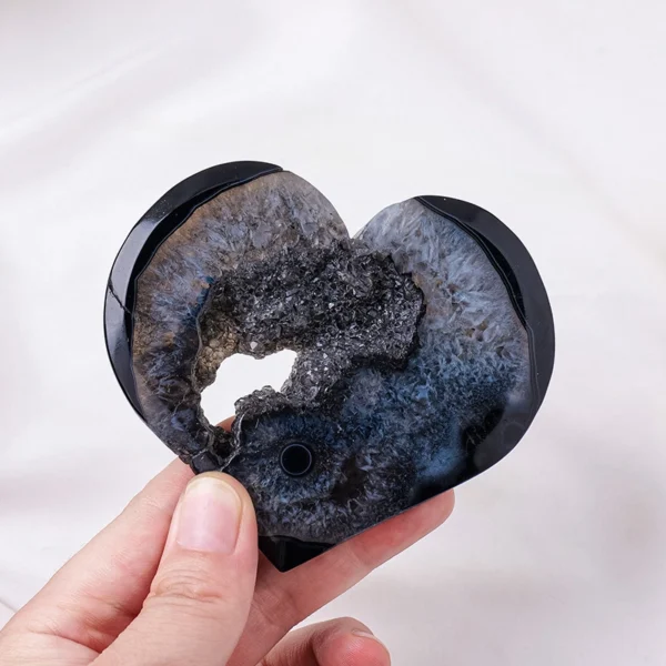 Dark and grounding, this Black Druzy Agate Heart offers steady protection and emotional anchoring. Featuring a sparkling druzy core and deep black agate exterior, it rests on a minimalist metal stand to stabilize your space while shielding against unwanted energy during times of stress or transition.