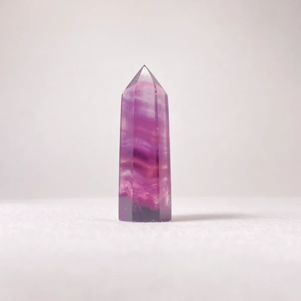 The Fluorite Mini Point is a crystal of clarity, insight, and inspired focus. Revered for its ability to organize thoughts and awaken intuition, it supports creative flow, mental discipline, and spiritual awareness. Its pointed form helps channel refined energy, making it ideal for learning, meditation, and moments requiring both imagination and precision.