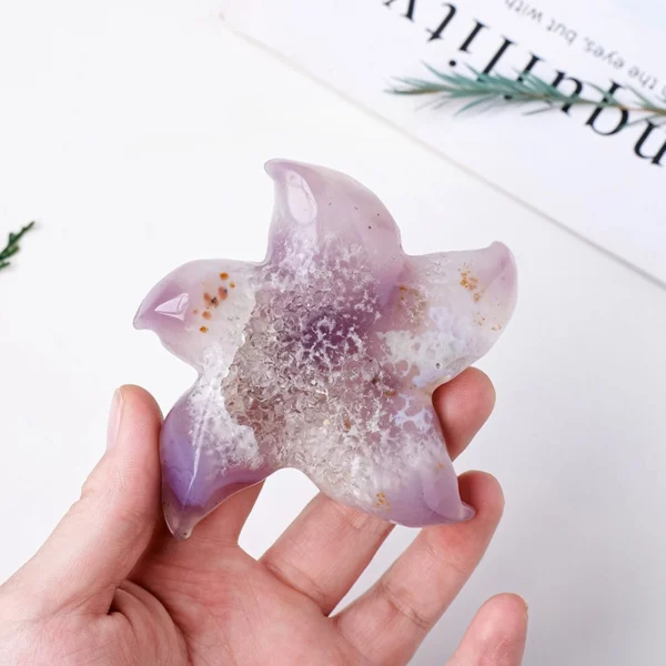 Radiating gentle vitality, the Druzy Agate Starfish supports physical healing and steady renewal. Hand-carved with a shimmering druzy center, it reflects resilience, balance, and heart-centered energy. This symbolic ocean form brings calming strength and restorative presence to spaces dedicated to healing and well-being.