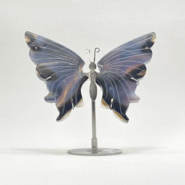 Carved from deep black agate, this Crystal Butterfly sculpture embodies grounding strength and graceful transformation. Resting on a refined metal stand, it anchors your space with protective energy while symbolizing the courage to release the past and embrace profound change. A powerful spiritual accent for moments of transition.