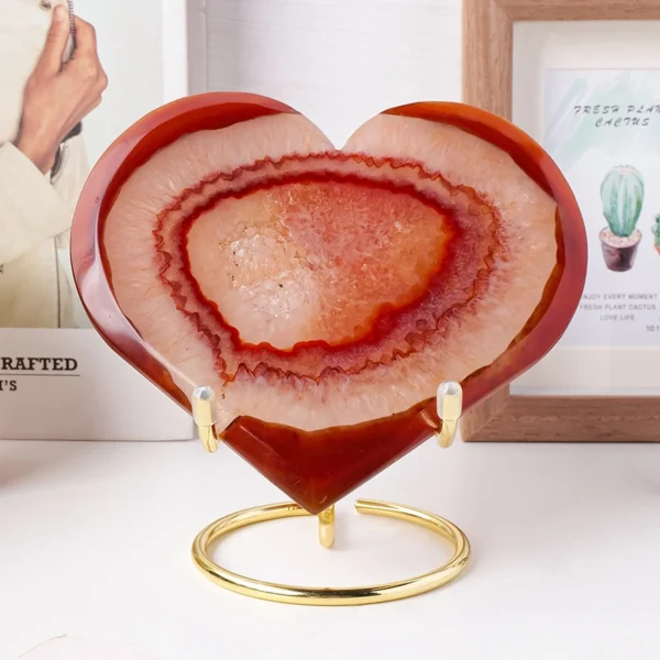 Glowing with raw vitality, this Red Druzy Agate Heart radiates warmth, strength, and embodied energy. Formed with shimmering red druzy crystals and elevated on a refined metal stand, it supports physical renewal and emotional flow while bringing a bold, grounding presence to your sacred or living space.