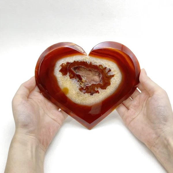 Glowing with raw vitality, this Red Druzy Agate Heart radiates warmth, strength, and embodied energy. Formed with shimmering red druzy crystals and elevated on a refined metal stand, it supports physical renewal and emotional flow while bringing a bold, grounding presence to your sacred or living space.