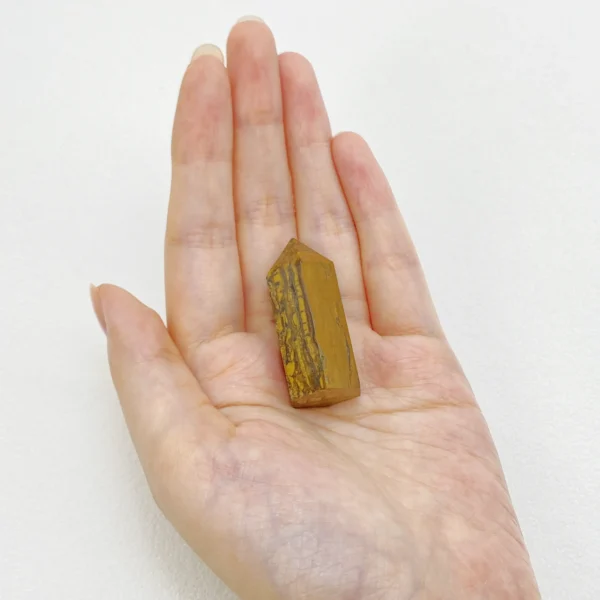 The Tigers Eye Mini Point is a crystal of courage, confidence, and steady motivation. Its golden-brown bands channel grounded strength while encouraging clear self-expression. Ideal for moments requiring bravery, focus, and personal power, it supports you in standing tall within complex social and professional environments.
